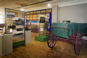 museum display of wooden wagon and exhibits